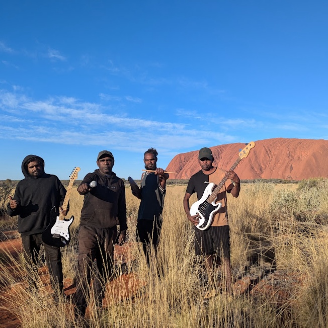 Mutitjulu Band posting in front of Uluru.